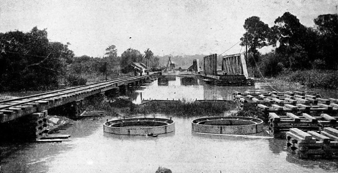 The construction of girders across the Korok River in Malaya during the building of a railway bridge