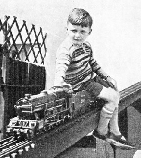 At the throttle of a ¾-in scale Southern locomotive on a garden railway in Surrey