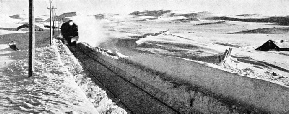 A SNOW CUTTING is being threaded by an express on the Oslo-Bergen Railway