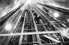 An impressive view of men at work on the new escalator at Leicester Square Tube Station.