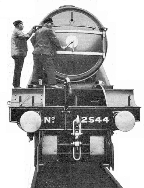 The Driver screws home the fastener of the smoke-box cover (LNER No. 2544 Lemberg)