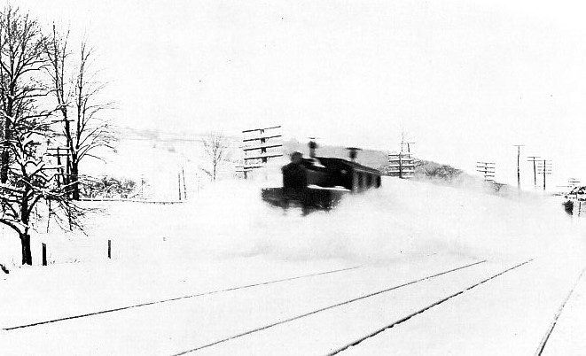 An Electric locomotive driving through a snowdrift