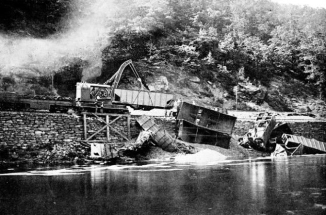 An Industrial Works 70-ton crane clearing the debris of a derailed train