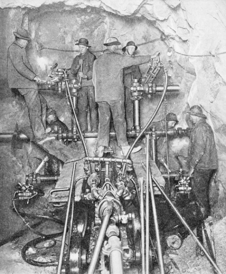 A working face, showing a powerful drilling machine in action during the boring of the great Cascade Tunnel