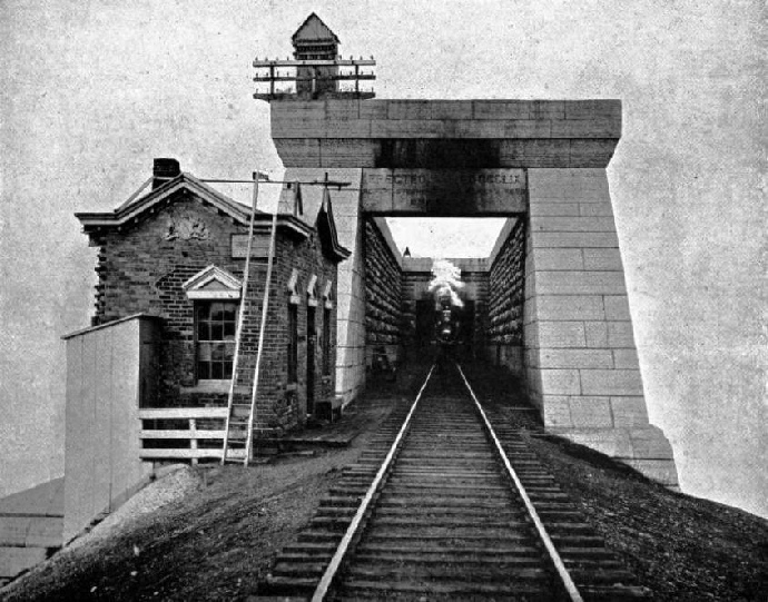 TRAIN EMERGING FROM THE OLD VICTORIA TUBULAR BRIDGE 