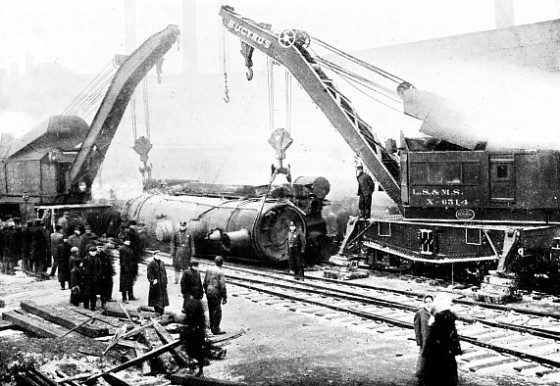 TWO 70-TON CRANES ABOUT TO SLING a capsized locomotive