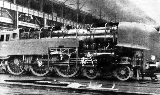 STREAMLINED COVERING of German steam locomotive partly removed to show boiler