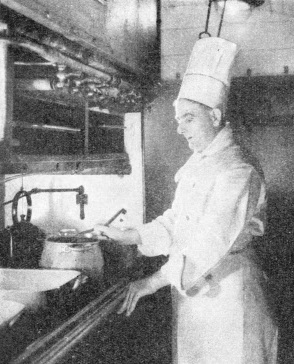 The Chef of the train preparing a meal